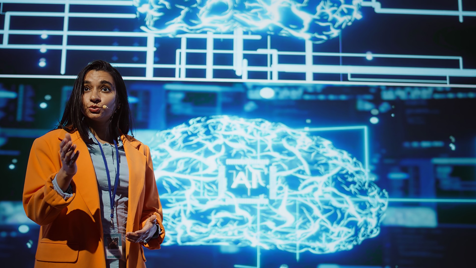 Speaker talking on stage in event bringing together leading AI experts